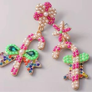 Festive multi colored mixed matched candy cane earrings.